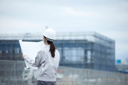 Construction site and woman in work clothesの写真素材