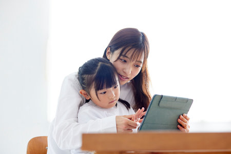 Japan father and daughter using tablet in living room