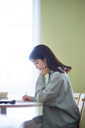 Japan woman studying in the libraryの写真素材