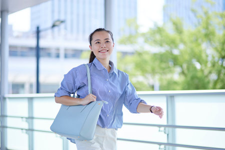 Japan woman commuting to work in summer business districtの写真素材