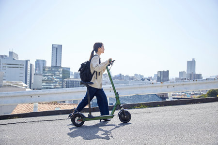 Japan woman traveling on an electric scooterの写真素材