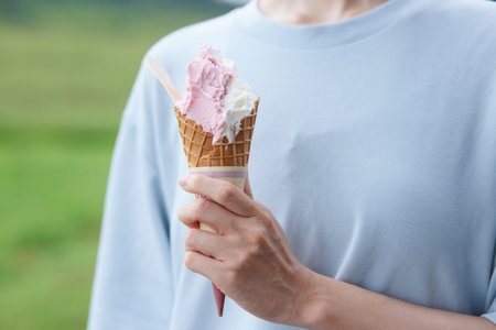 Japan woman eating gelato at a ranchの写真素材