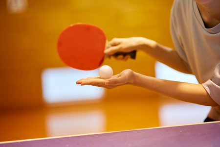 Japan woman wearing sportswear practicing table tennis in gymnasiumの写真素材