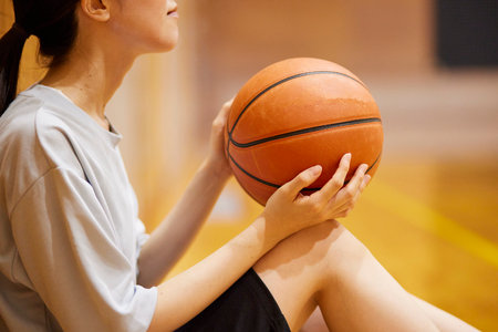 Japan woman in sportswear practicing basketball in gymnasiumの写真素材