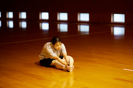 Japan woman wearing sportswear stretching in gymnasiumの写真素材