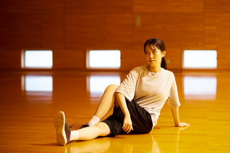 Japan woman wearing sportswear stretching in gymnasiumの写真素材