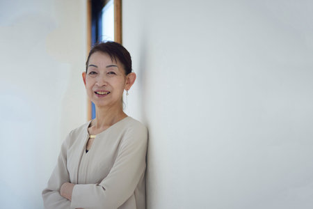 Senior female business owner in suit working in officeの写真素材