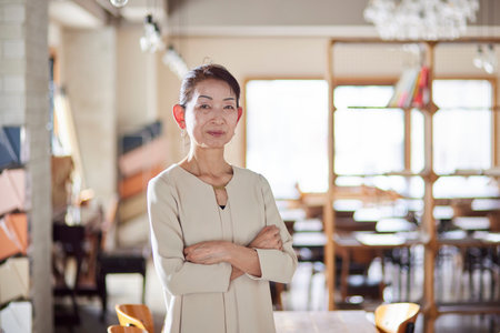 Senior female business owner in suit working in officeの写真素材