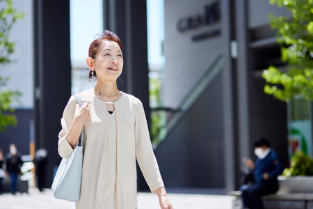 Senior female president working in an office district in springの写真素材