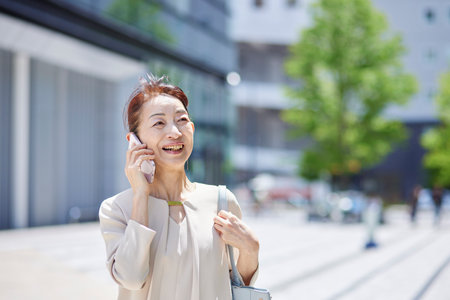 Senior female president working in an office district in springの写真素材