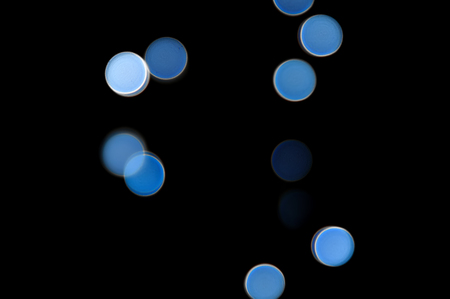 Abstract blurred blue lights on black background with copy space.の写真素材