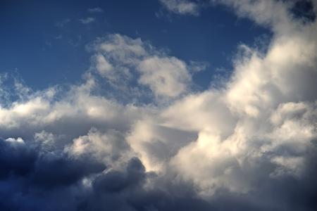 White clouds in a dark stormy sky.の写真素材