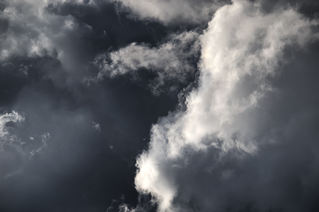 White clouds in a dark stormy sky.の写真素材
