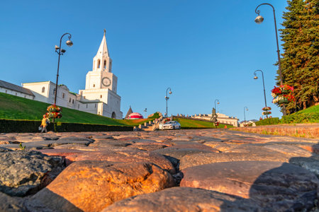 Cobblestone road close-up side view. Landscape old town with side evening sunlight.の写真素材