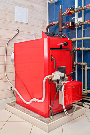 Gas boiler in the boiler room of a country private house. Country house with warmth and comfort.の写真素材