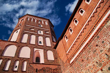 08.09.2021, Belarus-The Mir castle tower of the 16th century. Medieval fortress with brick on the background of the sky, sunny summer dayのeditorial素材