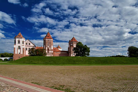08.09.2021, Belarus-Mir castle of the 16th century with towers. Medieval fortress with brick on the background of the sky, sunny summer day.のeditorial素材