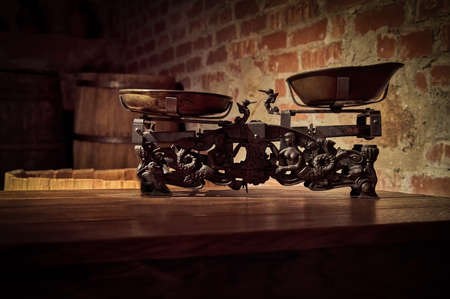 The silhouette of the old weight scales in the basement of the castle against the background of a brick wallの写真素材
