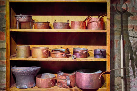 Old copper dishes on wooden shelves, vintage.の写真素材