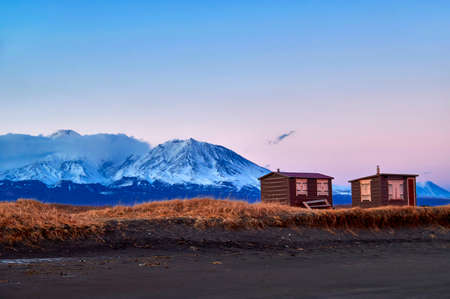 Evening autumn mountain landscape, snow-capped mountain peaks in the orange rays of the sun.の写真素材