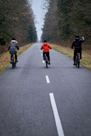 Family cycling in autumn park.の写真素材