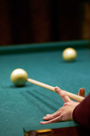 Hand with billiard cue. Billiards, a womans hand directs the cue to strikeの写真素材
