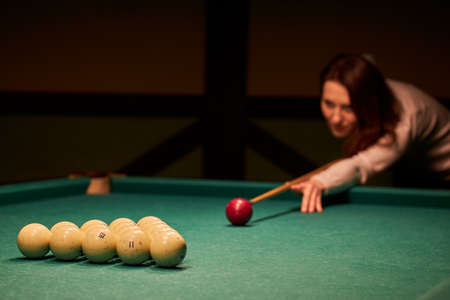 Blurry silhouette of a girl playing billiards.の写真素材