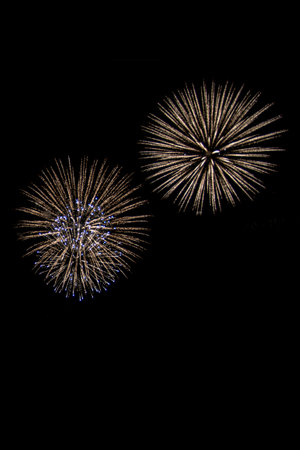 Beautiful abstract pattern with salute fireworks on dark background. Holiday card design. Colorful background. Happy festive background.の写真素材