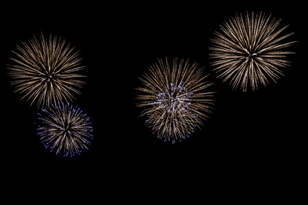 Beautiful abstract pattern with salute fireworks on dark background. Holiday card design. Colorful background. Happy festive background.の写真素材