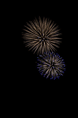 Beautiful abstract pattern with salute fireworks on dark background.の写真素材