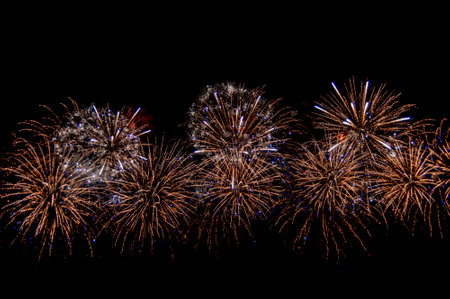 Beautiful abstract pattern with salute fireworks on dark background.の写真素材
