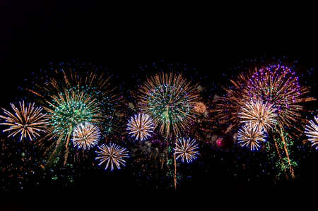 Beautiful abstract pattern with salute fireworks on dark background.の写真素材