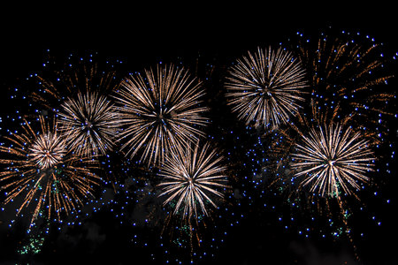 Beautiful abstract pattern with salute fireworks on dark background.の写真素材