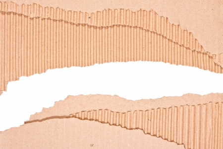 Hole ripped in corrugated cardboard on white background  with space for text or imageの写真素材