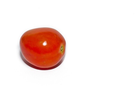 Tomato with shadow isolated on whiteの写真素材