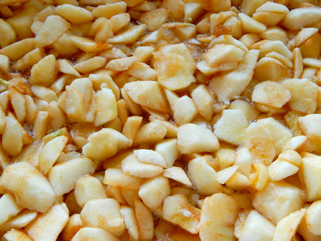 apples sliced in slices of squares, apple jam is brewedの写真素材