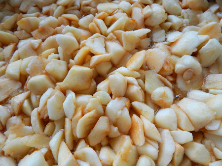 apples sliced in slices of squares, apple jam is brewedの写真素材