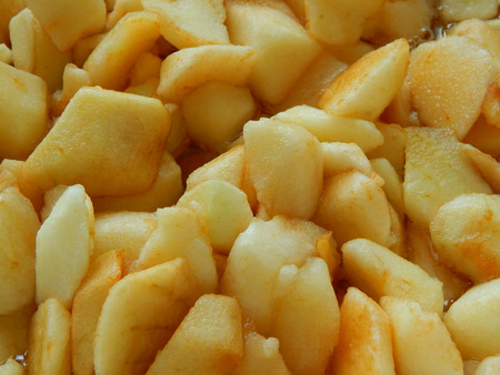 apples sliced in slices of squares, apple jam is brewedの写真素材