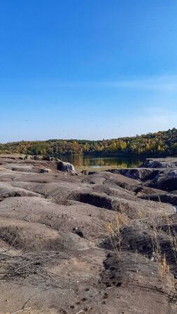 Abandoned and flooded quarry for coal mining. Horizontal photo.の写真素材