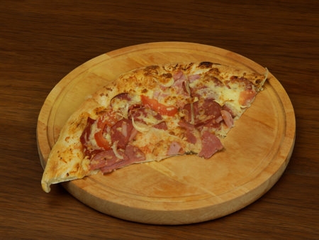 Pizza with salami sausage, mozzarella cheese, mushrooms, black olives, spicy tomato sauce and arugula, rustic wooden table background, top view.の写真素材