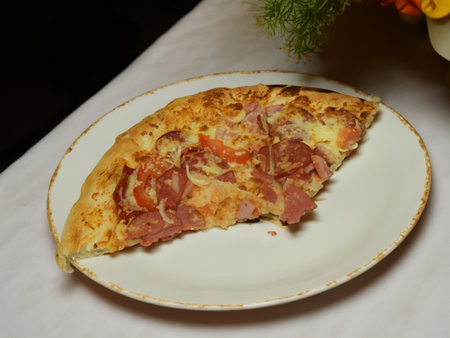 Pizza with salami sausage, mozzarella cheese, mushrooms, black olives, spicy tomato sauce and arugula, rustic wooden table background, top view.の写真素材