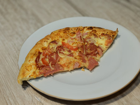 Pizza with salami sausage, mozzarella cheese, mushrooms, black olives, spicy tomato sauce and arugula, rustic wooden table background, top view.の写真素材