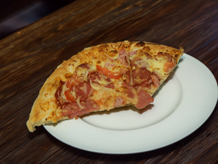 Pizza with salami sausage, mozzarella cheese, mushrooms, black olives, spicy tomato sauce and arugula, rustic wooden table background, top view.の写真素材