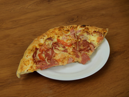 Pizza with salami sausage, mozzarella cheese, mushrooms, black olives, spicy tomato sauce and arugula, rustic wooden table background, top view.の写真素材