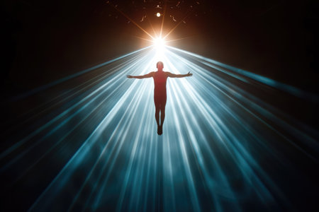 A figure stands with arms outstretched, bathed in brilliant light rays, creating a powerful visual impact.の素材