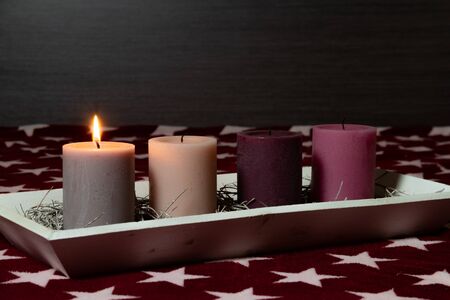 Plain Christmas decoration for the 1st Sunday of Advent. One candle is already lit up and the Christmas time of the year startsの写真素材