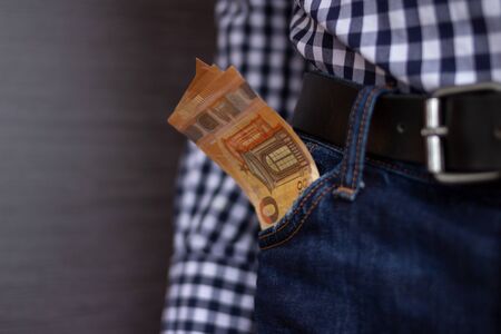 Euro bills in jeans pocket background. 50 Euro banknotes as a concept for people saving or spending moneyの写真素材