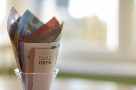 Saving euro banknotes in a jar at home concept background