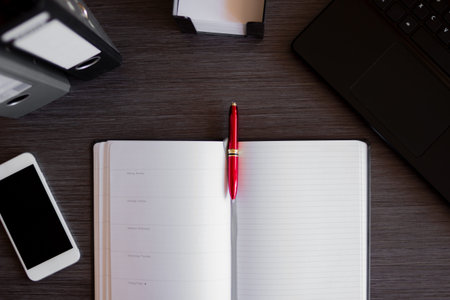 Top view modern office desk with laptop, smartphone, notebook and other supplies. Office concept with documents and digital devices. New innovative technology and efficient workflowsの写真素材