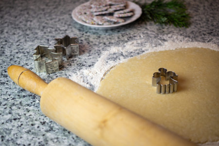 Christmas Bakery Cookie Dough and Angel Cutter. Top view christmas biscuit dough and green spruce...